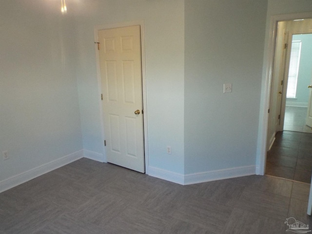 empty room featuring baseboards