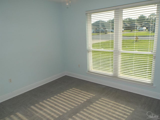 empty room featuring baseboards