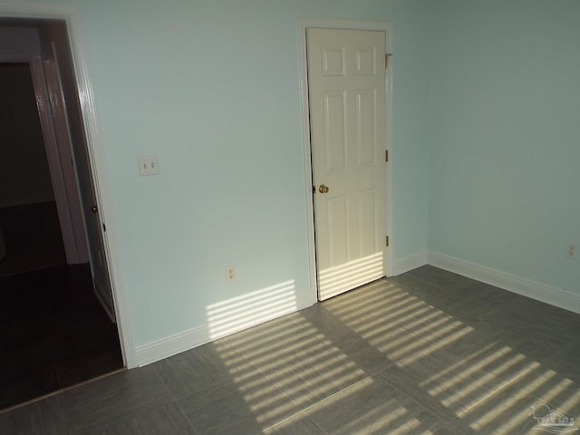 spare room featuring baseboards