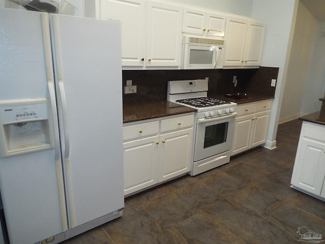 kitchen with white appliances, white cabinets, and tasteful backsplash