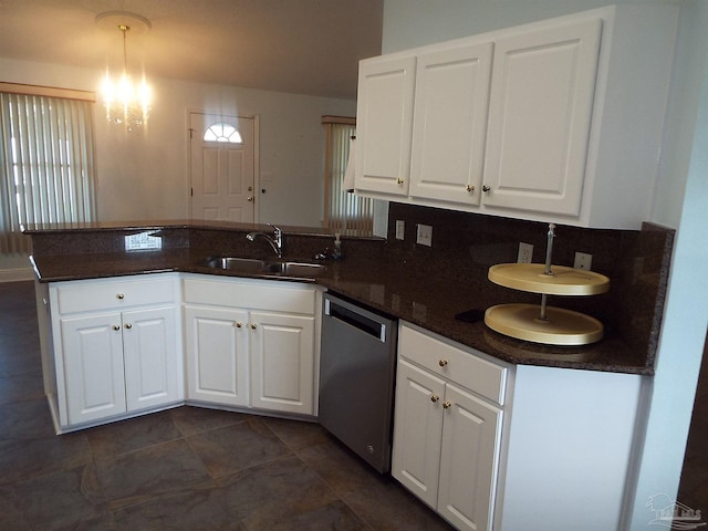 kitchen featuring stainless steel dishwasher, a peninsula, a sink, and white cabinetry