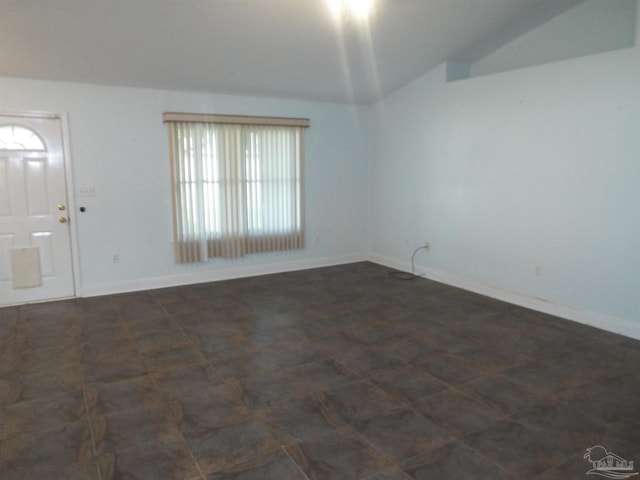 unfurnished room with lofted ceiling and baseboards