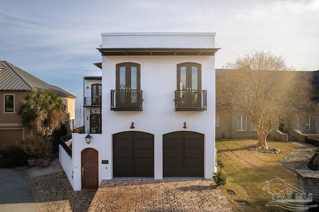 view of front facade with a garage and a balcony