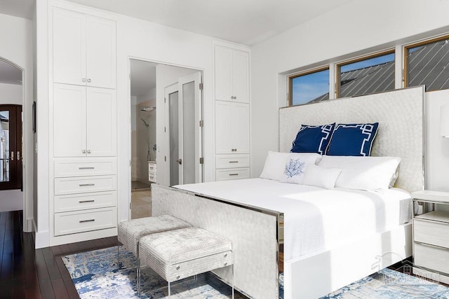 bedroom with dark wood-type flooring