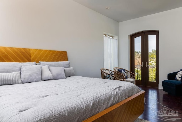 bedroom featuring french doors, dark hardwood / wood-style floors, and access to outside