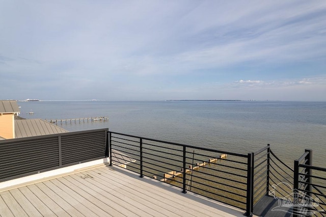 wooden terrace featuring a water view