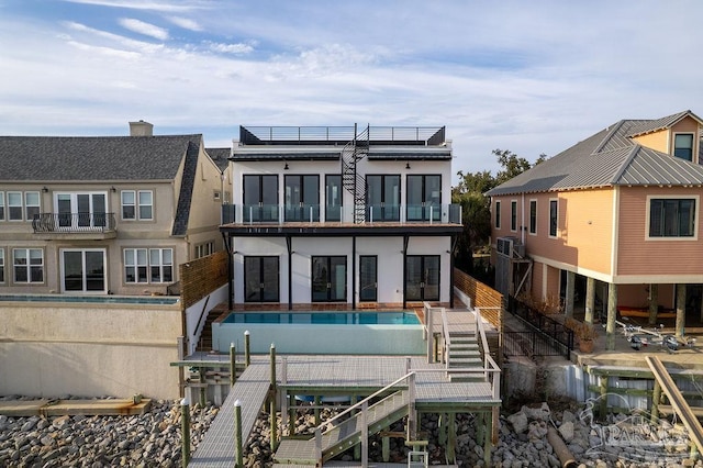 rear view of property featuring solar panels