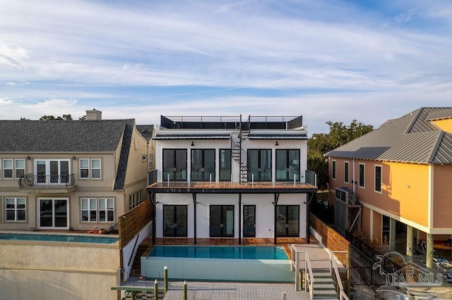 rear view of property with solar panels