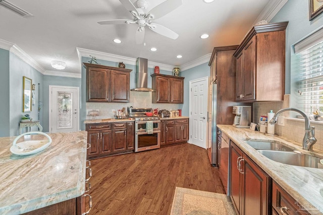 5757 Cobble Creek Dr, Pace, FL 32571 - kitchen featuring stainless steel appliances, wall chimney exhaust hood, a sink, recessed lighting, and a ceiling fan