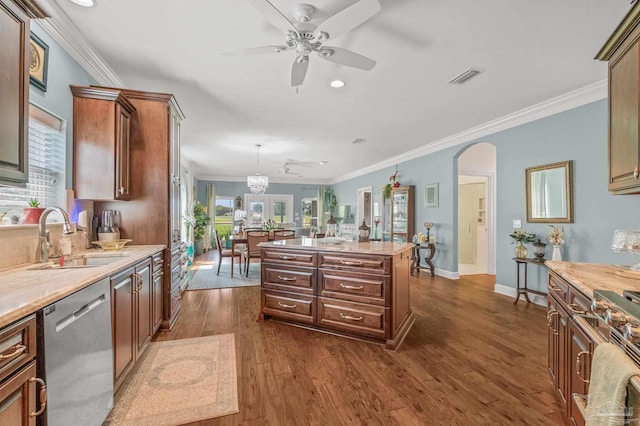 5757 Cobble Creek Dr, Pace, FL 32571 - kitchen featuring appliances with stainless steel finishes, a sink, a ceiling fan, arched walkways, and light countertops