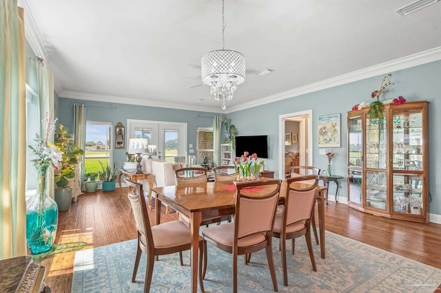 5757 Cobble Creek Dr, Pace, FL 32571 - dining space with a chandelier, hardwood / wood-style floors, ornamental molding, french doors, and baseboards