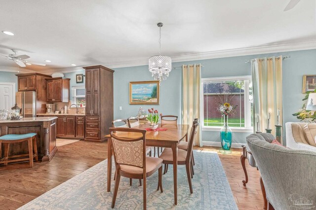 5757 Cobble Creek Dr, Pace, FL 32571 - dining room with a chandelier, crown molding, ceiling fan, light wood-style flooring, and recessed lighting