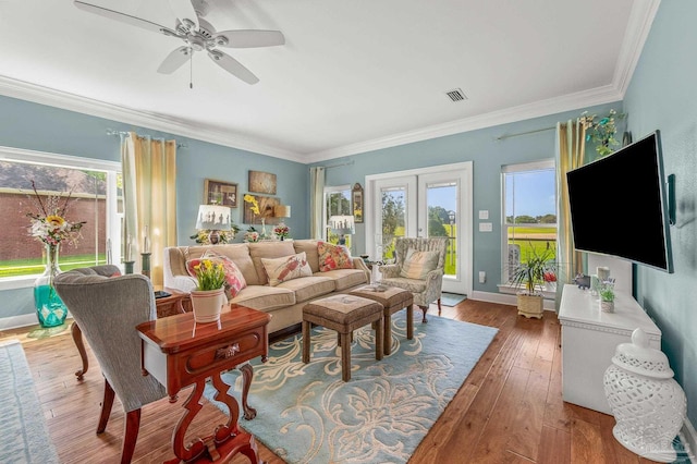 5757 Cobble Creek Dr, Pace, FL 32571 - living area featuring healthy amount of natural light, crown molding, hardwood / wood-style flooring, ceiling fan, and baseboards