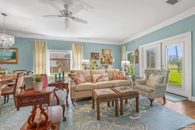 5757 Cobble Creek Dr, Pace, FL 32571 - living room featuring crown molding, wood finished floors, a ceiling fan, a chandelier, and french doors