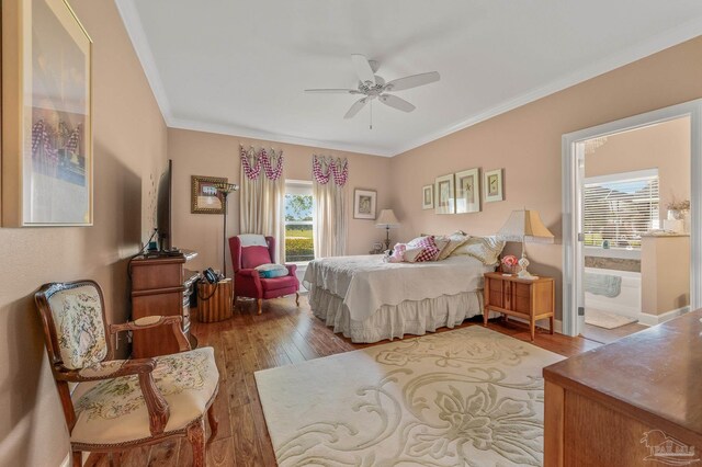 5757 Cobble Creek Dr, Pace, FL 32571 - bedroom featuring wood finished floors, crown molding, connected bathroom, and ceiling fan