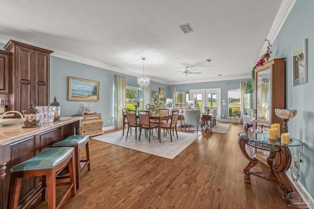 5757 Cobble Creek Dr, Pace, FL 32571 - dining area featuring hardwood / wood-style flooring, plenty of natural light, a ceiling fan, crown molding, and baseboards