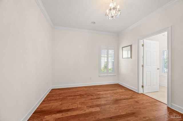 5757 Cobble Creek Dr, Pace, FL 32571 - empty room featuring ornamental molding, a chandelier, wood finished floors, and baseboards