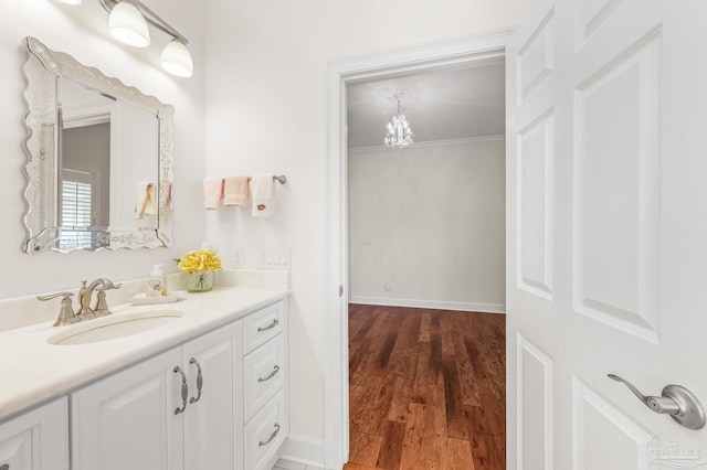 5757 Cobble Creek Dr, Pace, FL 32571 - bathroom featuring vanity, wood finished floors, baseboards, and a chandelier