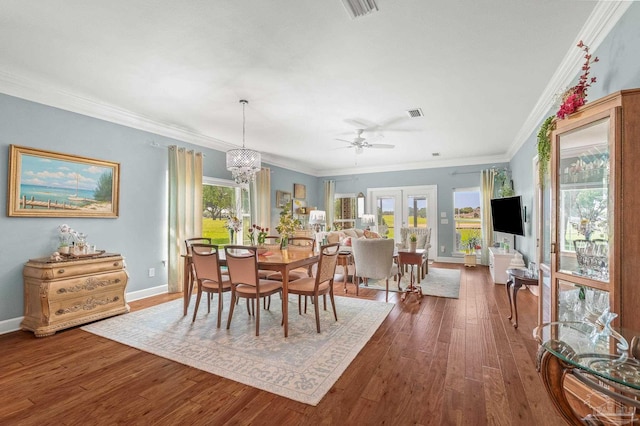 5757 Cobble Creek Dr, Pace, FL 32571 - dining area featuring dark wood finished floors, a ceiling fan, crown molding, baseboards, and a chandelier