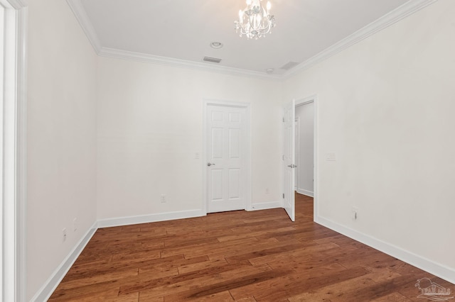 5757 Cobble Creek Dr, Pace, FL 32571 - unfurnished room featuring crown molding, a chandelier, wood finished floors, and baseboards