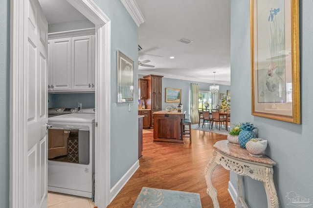 5757 Cobble Creek Dr, Pace, FL 32571 - hall featuring independent washer and dryer, ornamental molding, light wood finished floors, baseboards, and recessed lighting