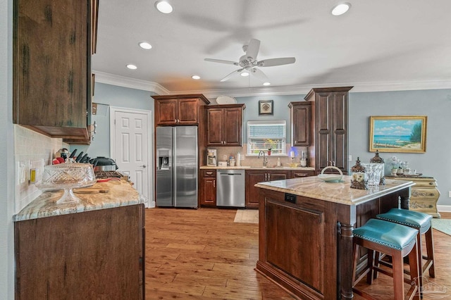 5757 Cobble Creek Dr, Pace, FL 32571 - kitchen featuring stainless steel appliances, recessed lighting, a sink, ornamental molding, and dark brown cabinets