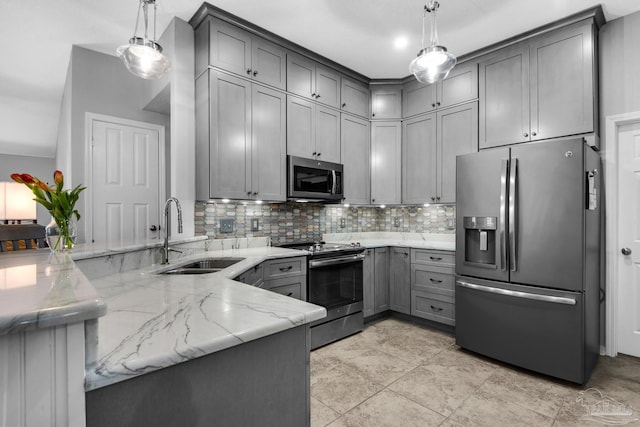 3774 Mcnemar Ct, Gulf Breeze, FL 32563 - kitchen featuring stainless steel appliances, a sink, gray cabinets, light stone counters, and a peninsula