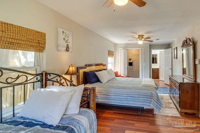 bedroom featuring connected bathroom, ceiling fan, and dark hardwood / wood-style floors