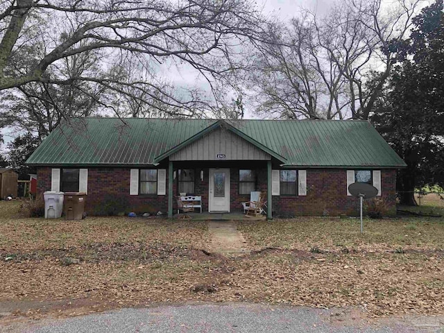 view of front facade with metal roof and brick siding