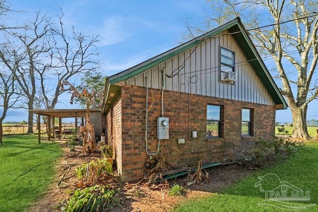 view of side of home with a yard, brick siding, board and batten siding, and cooling unit