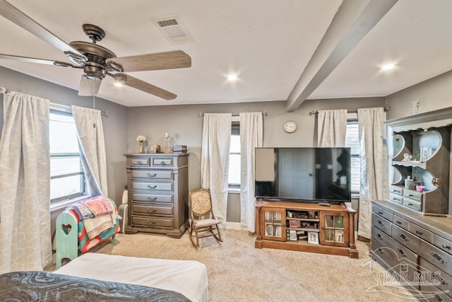 bedroom featuring ceiling fan, light colored carpet, and beamed ceiling