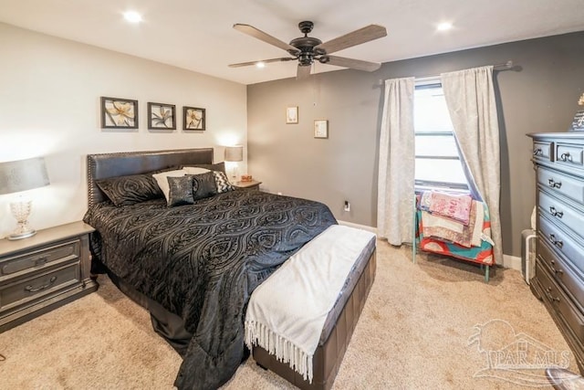 bedroom featuring a ceiling fan, recessed lighting, light colored carpet, and baseboards