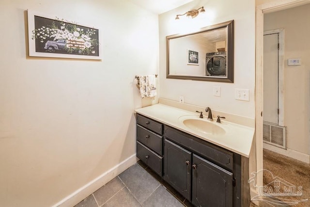 bathroom featuring tile patterned flooring and vanity