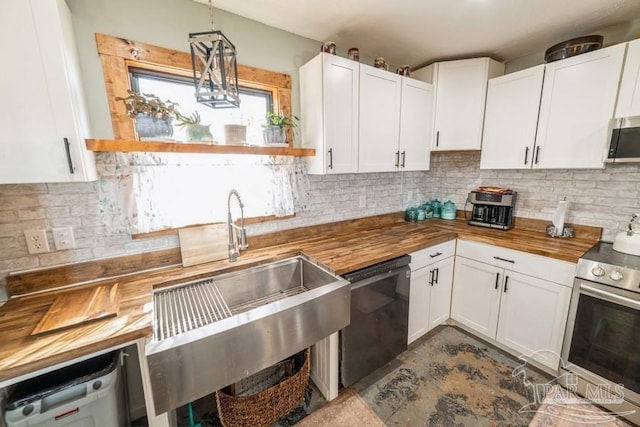 kitchen featuring white cabinetry, wood counters, appliances with stainless steel finishes, and pendant lighting