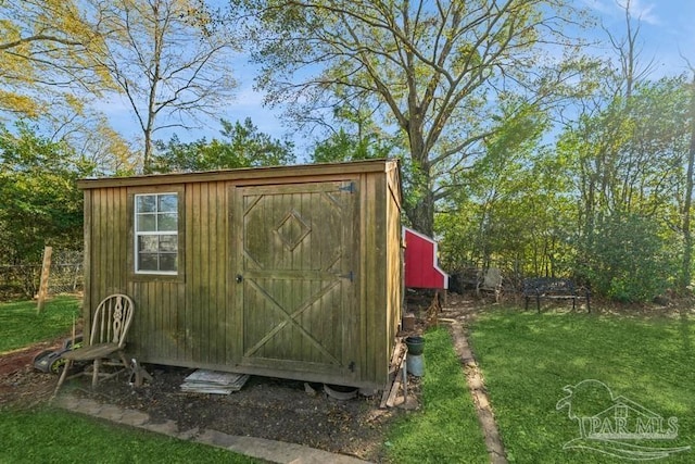 view of outdoor structure featuring a lawn