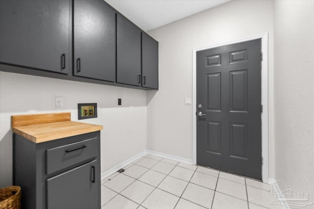 laundry room with light tile patterned flooring, hookup for a washing machine, cabinet space, and baseboards