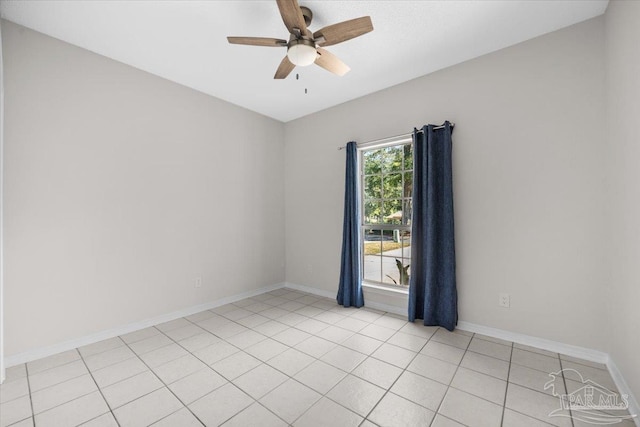 unfurnished room featuring light tile patterned floors, ceiling fan, and baseboards