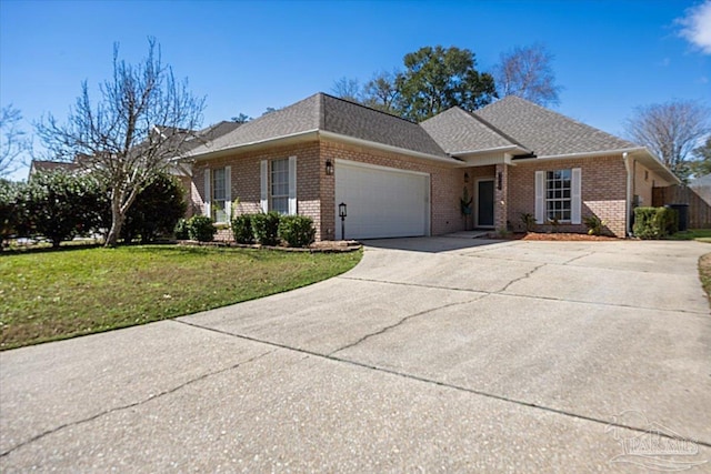 ranch-style house featuring concrete driveway, roof with shingles, an attached garage, a front lawn, and brick siding