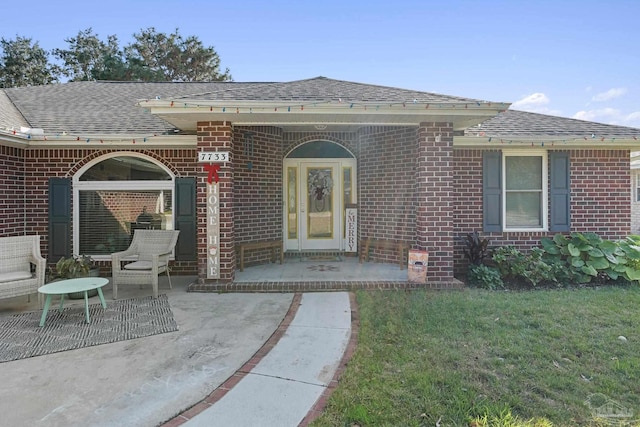 doorway to property featuring a yard