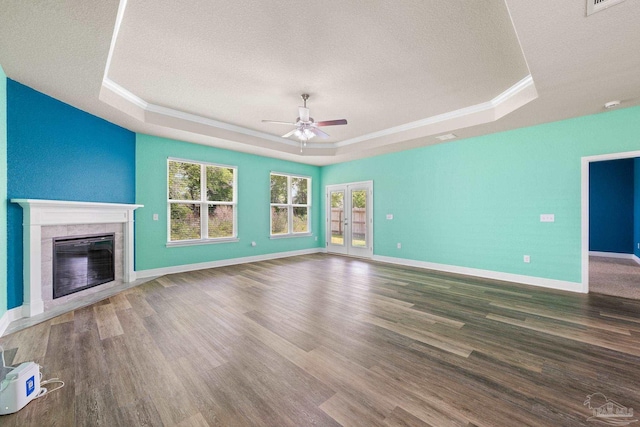 3826 Ranch Rd, Pace, FL 32571 - unfurnished living room featuring ceiling fan, wood finished floors, a textured ceiling, and a raised ceiling