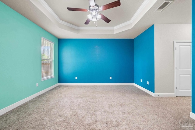 3826 Ranch Rd, Pace, FL 32571 - spare room featuring a tray ceiling, crown molding, visible vents, and carpet flooring