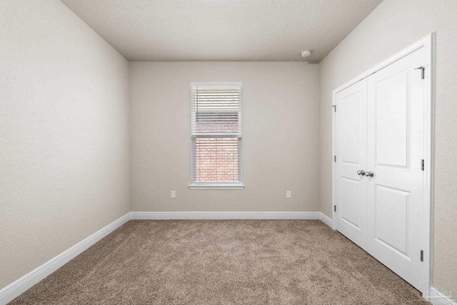 3826 Ranch Rd, Pace, FL 32571 - unfurnished bedroom featuring baseboards, carpet floors, and a closet