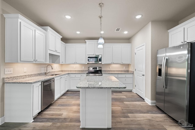 3826 Ranch Rd, Pace, FL 32571 - kitchen featuring a center island, stainless steel appliances, white cabinetry, and a sink