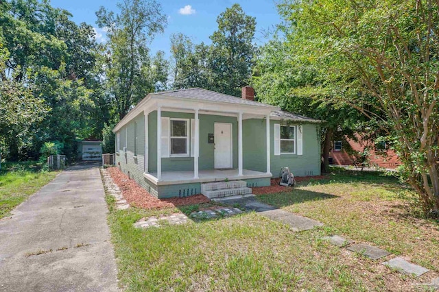 bungalow featuring a front yard and covered porch