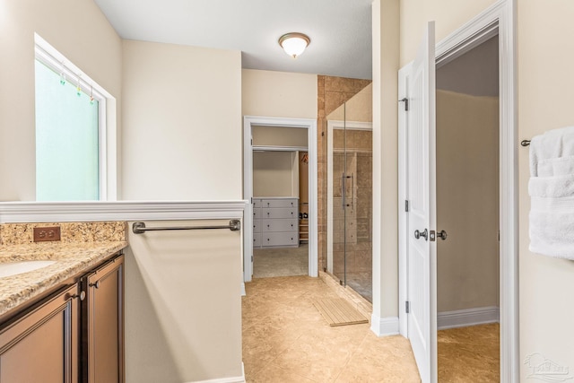 bathroom with tile patterned flooring, vanity, and an enclosed shower