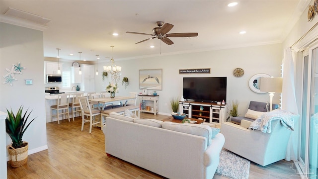 living room featuring crown molding, ceiling fan with notable chandelier, and light hardwood / wood-style floors