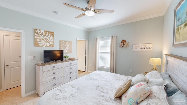 bedroom with light colored carpet, ornamental molding, and ceiling fan