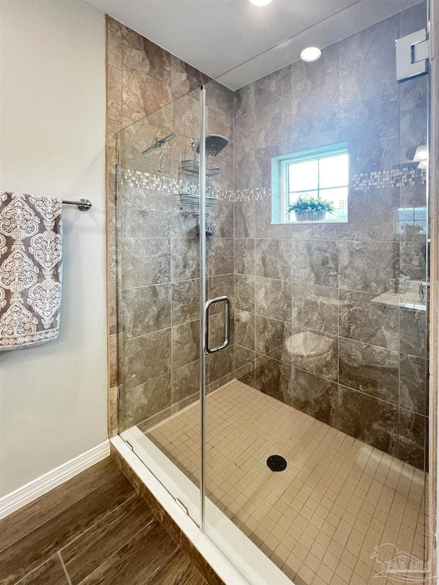 bathroom featuring walk in shower and hardwood / wood-style floors