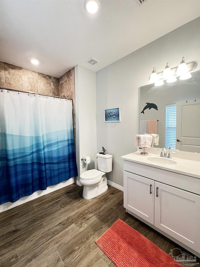 bathroom with a shower with curtain, wood-type flooring, toilet, and vanity