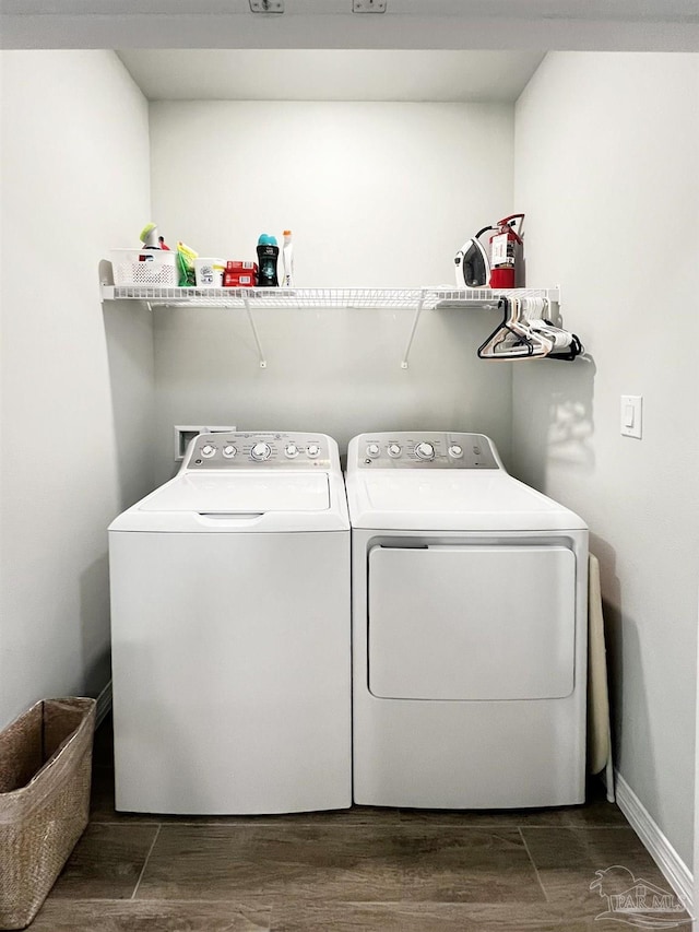 laundry room featuring washing machine and clothes dryer and dark hardwood / wood-style flooring